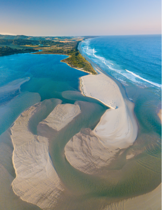 Sandy, coastal peninsula with turquoise water. 