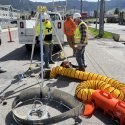 Workers installing autosamplers in butte stormwater system