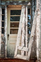 A picture containing lead paint peeling from old door and frames.