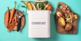 this is a picture of cutting boards, vegetables, and a compost bin.