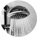 closeup of silver showerhead actively dispensing water